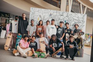 Group of mauritian Skaters posing in front of big doodle box, teens activities in mall